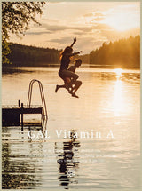 Zwei Personen springen in einen See bei Sonnenuntergang, neben einem Steg. Text mit "GAL Vitamin A" sichtbar.